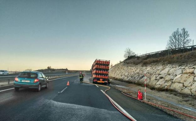 Los bomberos enfrían el eje del camión en la A-67. 