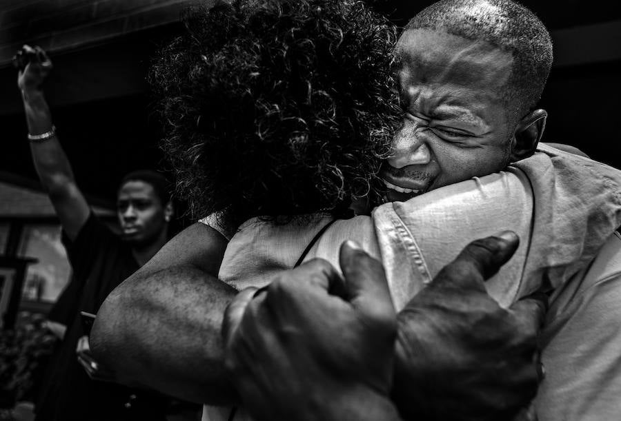 John Thompson es abrazado en St Anthony Village, Minnesota, EE. UU., tras su discurso en la manifestación conmemorativa por su amigo Philando Castile, dos días después de que el oficial de policía Jerónimo Yáñez fuera absuelto de todos los cargos por los disparos que acabaron con su vida.