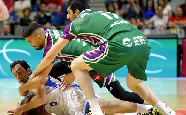 El jugador italiano del San Pablo Burgos Vitor Benite (i) lucha por el balón ante los jugadores del Unicaja Jaime Fernández (c) y el georgiano Giorgi Shermadini. 