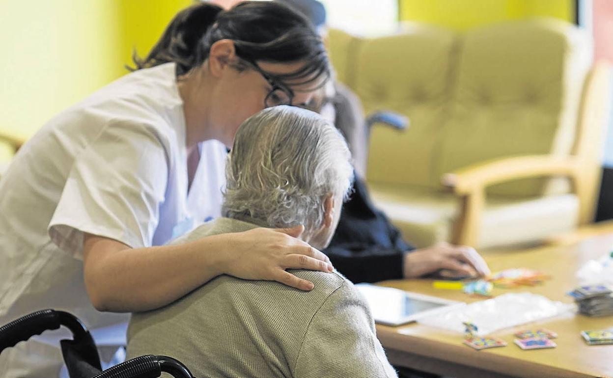 Una enfermera atiende a una mujer en una residencia.