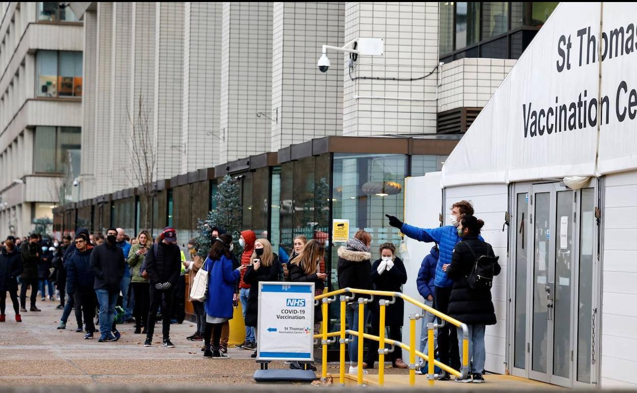 Jóvenes británicos hacen cola en el exterior del centro de vacunación abierto en el hospital St Thomas, en el centro de Londres.