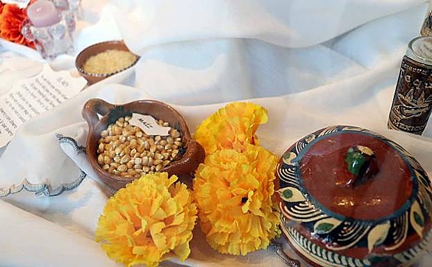Comida como el maíz, las flores de cempasúchil, el barro como símbolo de la tierra. 