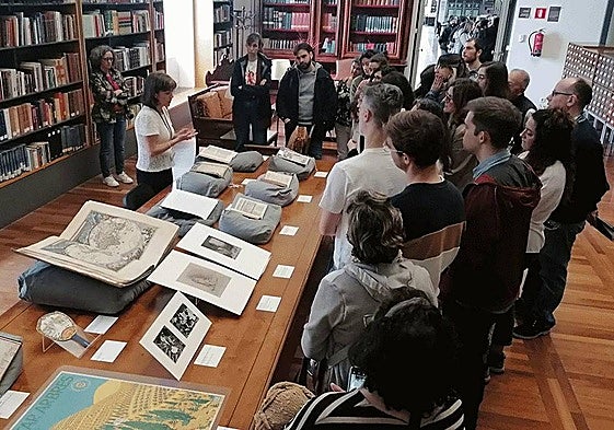 Imagen de archivo de una técnica de la Biblioteca Nacional mostrando ejemplares restaurados durante una visita guiada.