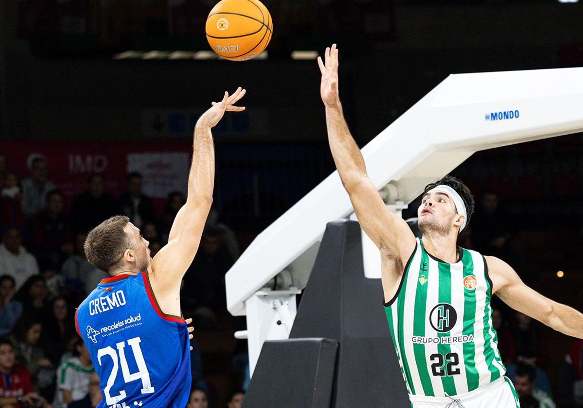 Cremo, lanzando a canasta ante un jugador del Real Betis.