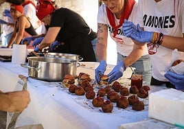 Colaboradores preparando dos de los pinchos con morcilla que se podían degustar en esta feria