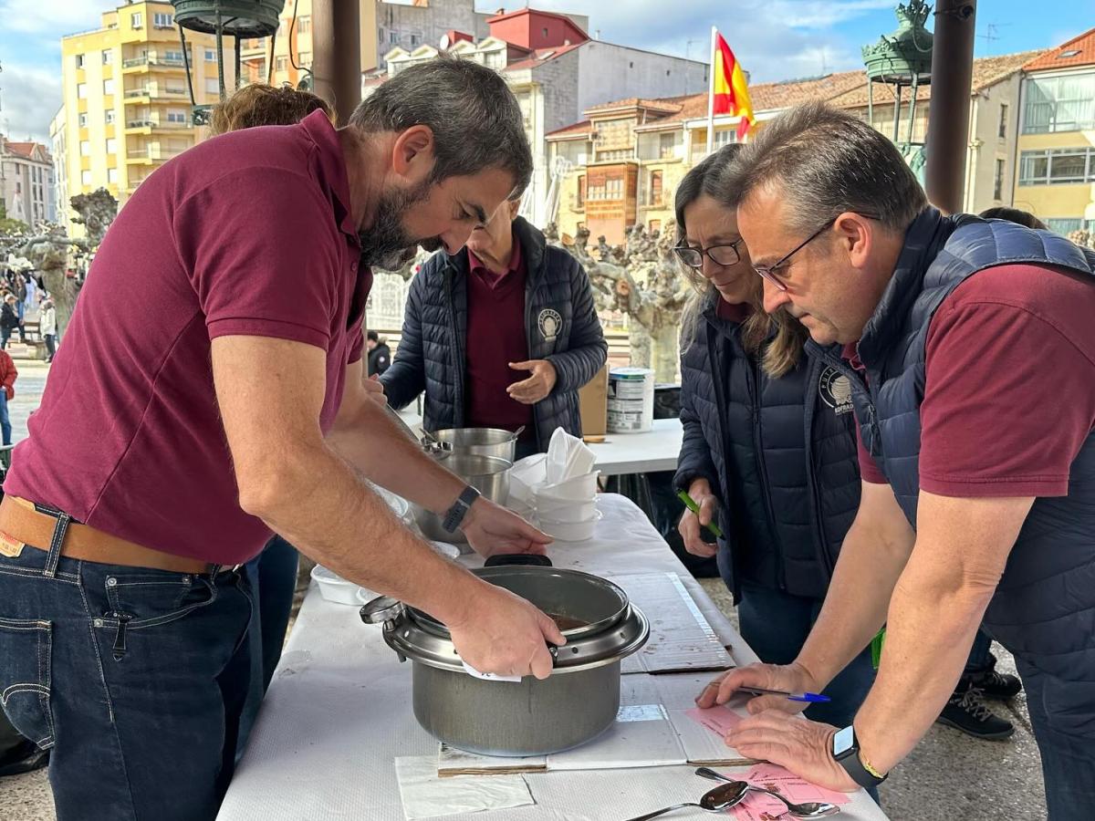 Imagen secundaria 2 - Alubias rojas, morcilla y el jurado catando una de las pucheras en una edición pasada. 