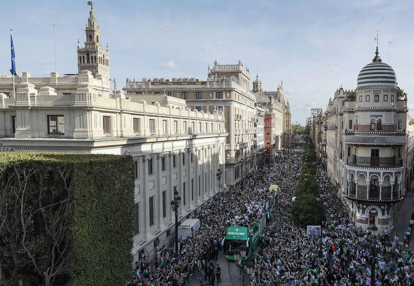 Una enorme multitud sigue al autocar con los jugadores del Betis durante su recorrido por la Avenida de la Constitución con destino al ayuntamiento de Sevilla, para celebrar su título de Copa del Rey.
