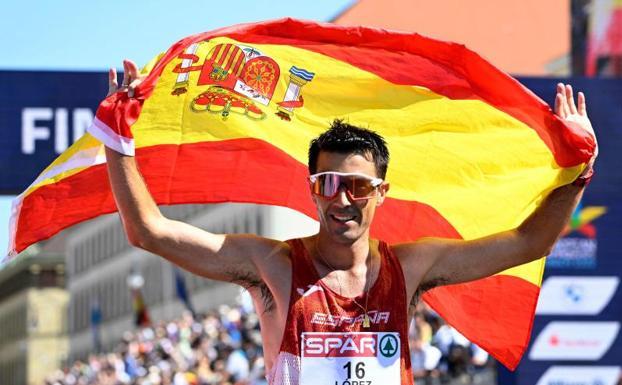 Miguel Ángel López cruza la línea de meta con la bandera de España.