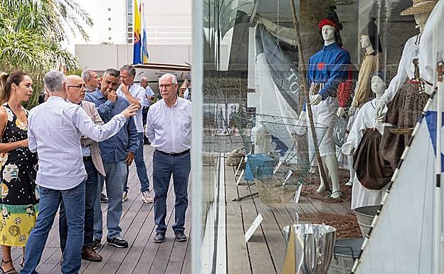 Autoridades del Cabildo ante el escaparate de la Casa Palacio con vestimental tradicional marinera. 
