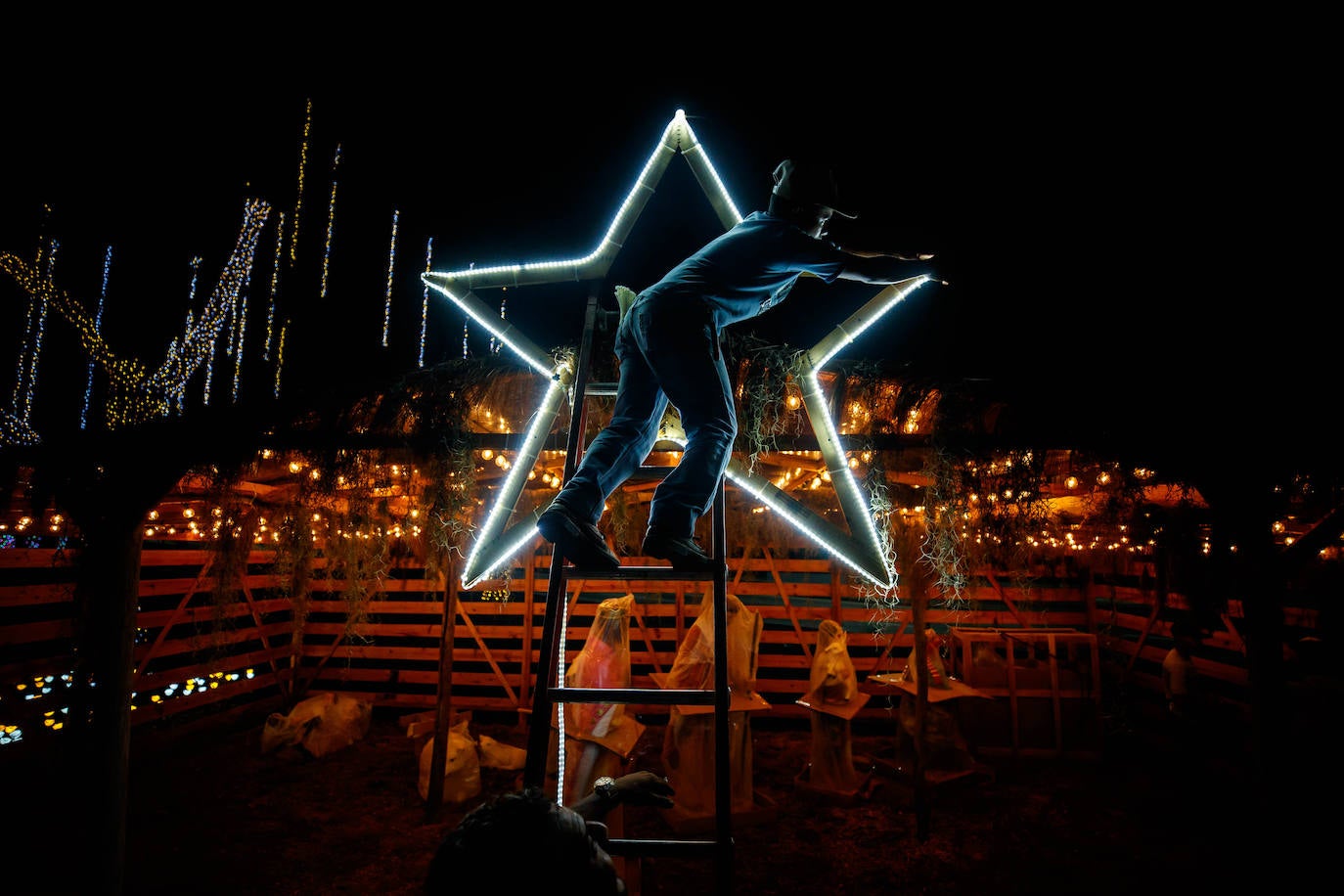 Un operario trabajando en la colocación de los adornos navideños y preparativos alegóricos en Caracas, Venezuela.