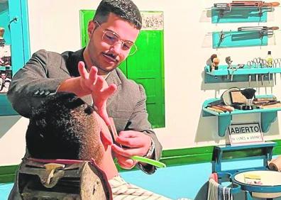 Imagen secundaria 1 - Arriba, Mamina, vecina del pueblo, prepara unas roscas. Debajo, Iván Luis García ejerce de barbero, oficio que heredó de su abuelo materno, José Vega; y Benedicta pone en práctica el oficio de lanería. 