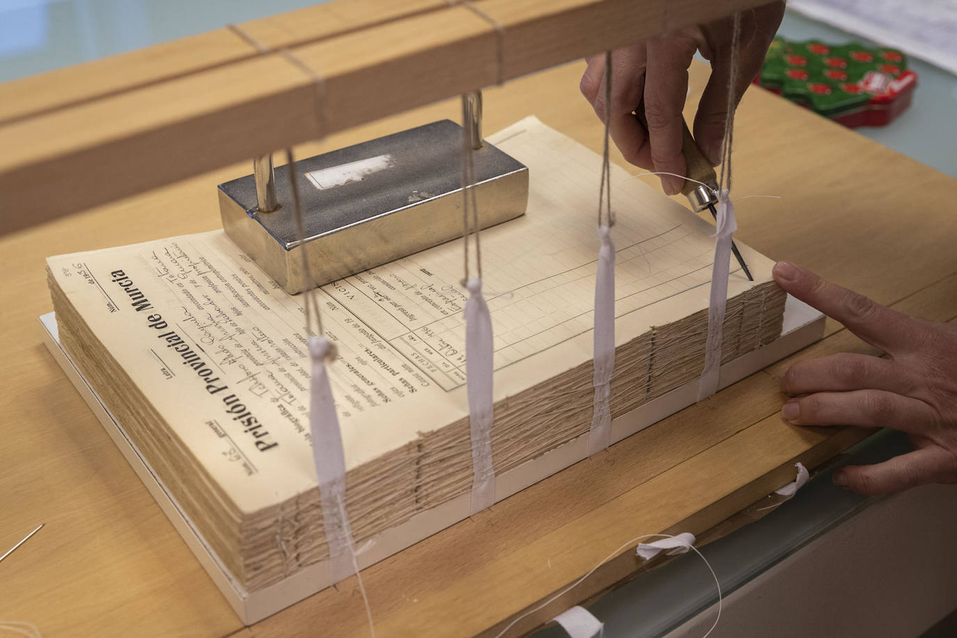 Hay libros históricos tan deteriorados que ni siquiera es posible pasar sus páginas. El taller de restauración del Archivo General de la Región de Murcia es el lugar donde esos documentos pueden recuperar su funcionalidad para volver a ser consultados tras someterse a un minucioso proceso de limpieza y recuperación completamente artesanal. Las manos responsables de llevar a cabo el proceso son las de Esther Marcos, la restauradora del Archivo General, donde se ubica el único taller de recuperación de documentos gráficos operativo de la comunidad autónoma.