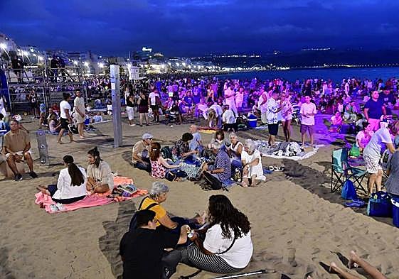 Cientos de personas se congregan en Las Canteras para vivir la víspera de San Juan.