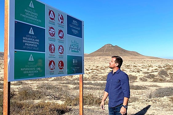 David Fajardo, concejal de Medio Ambiente del Ayuntamiento de La Oliva, en la nueva cartelería que intenta frenar grabados y expolios en el barranco de los Enamorados, en Lajares.