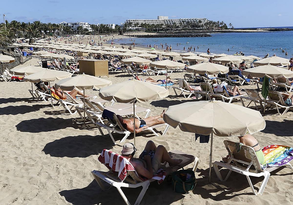Bañistas al sol en Las Cucharas, en Lanzarote.
