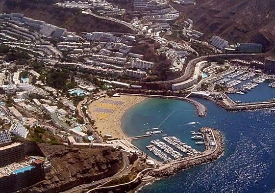 Vista de la playa y el muelle comercial de Puerto Rico, en Mogán.