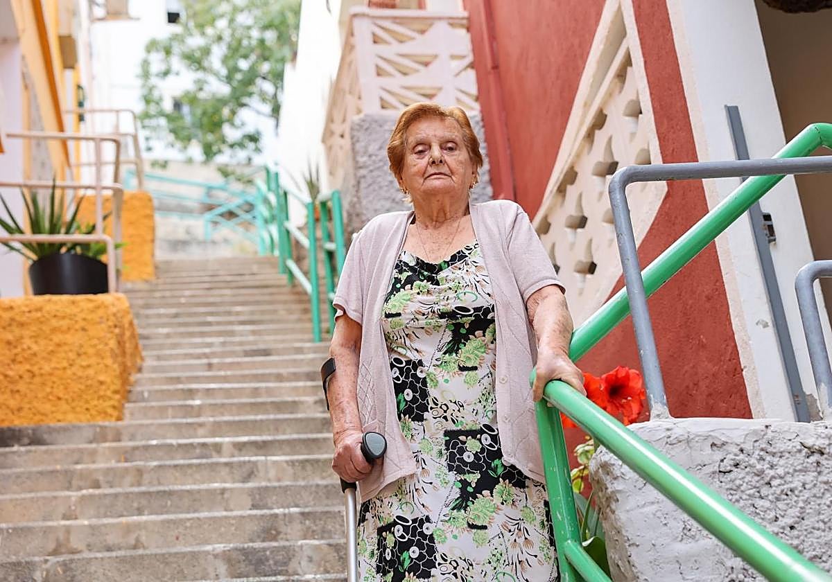 Inocencia Vega, en la puerta de su casa, en La Matula, se aferra al barandal.