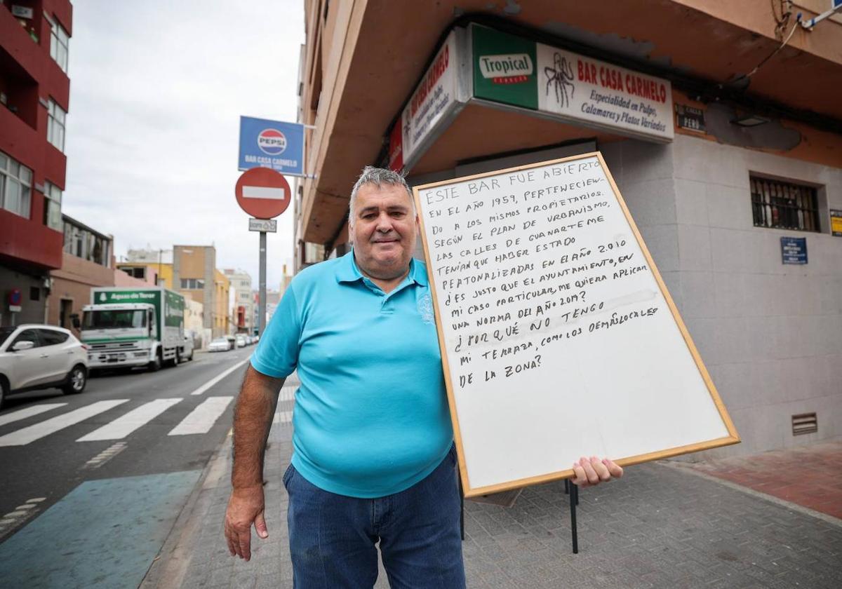 Luis Díaz Cabrera posa con la pizarra que le acompaña en la sentada de cada día.
