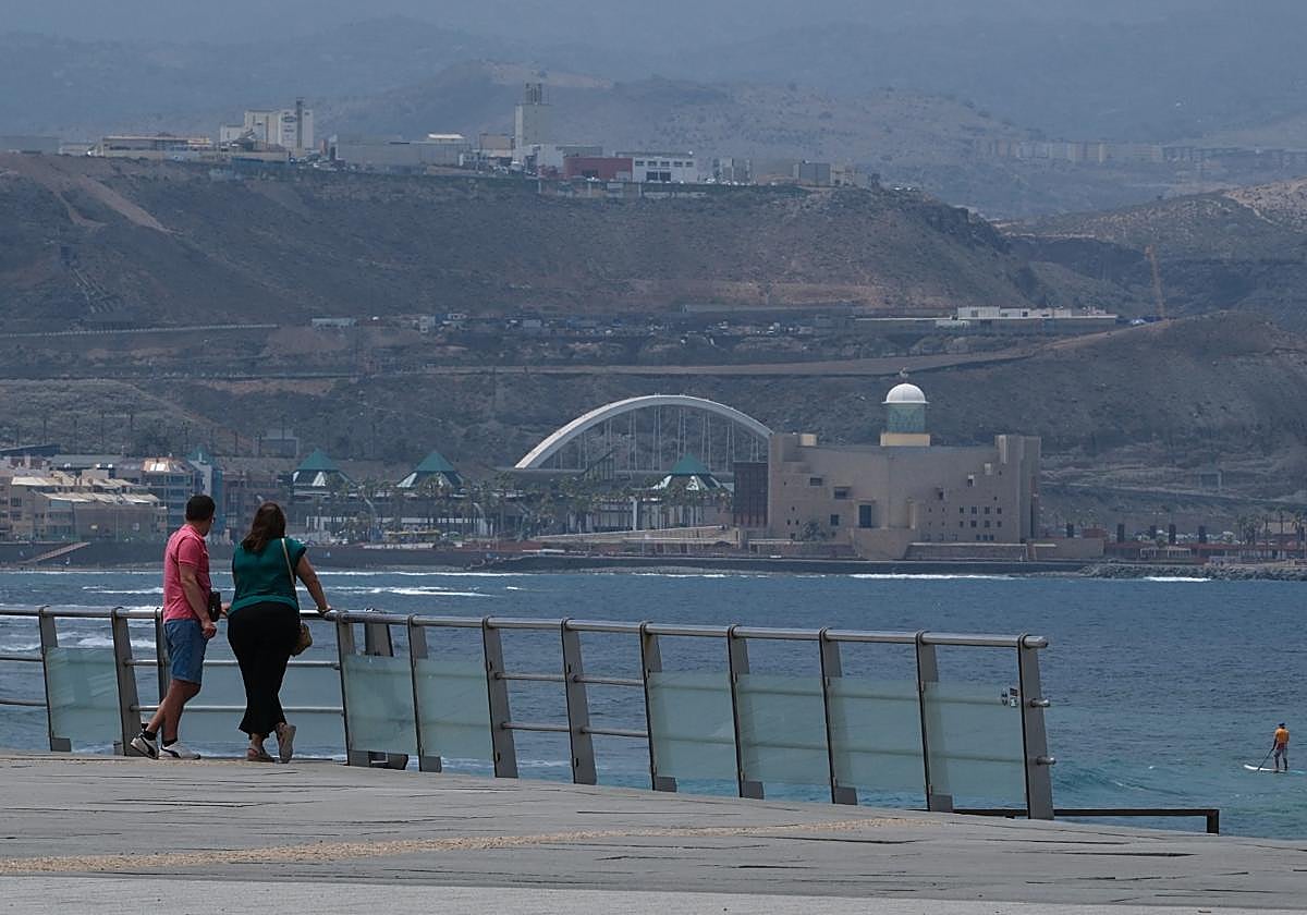 Una pareja admira el Auditorio Alfredo Kraus desde Las Canteras.