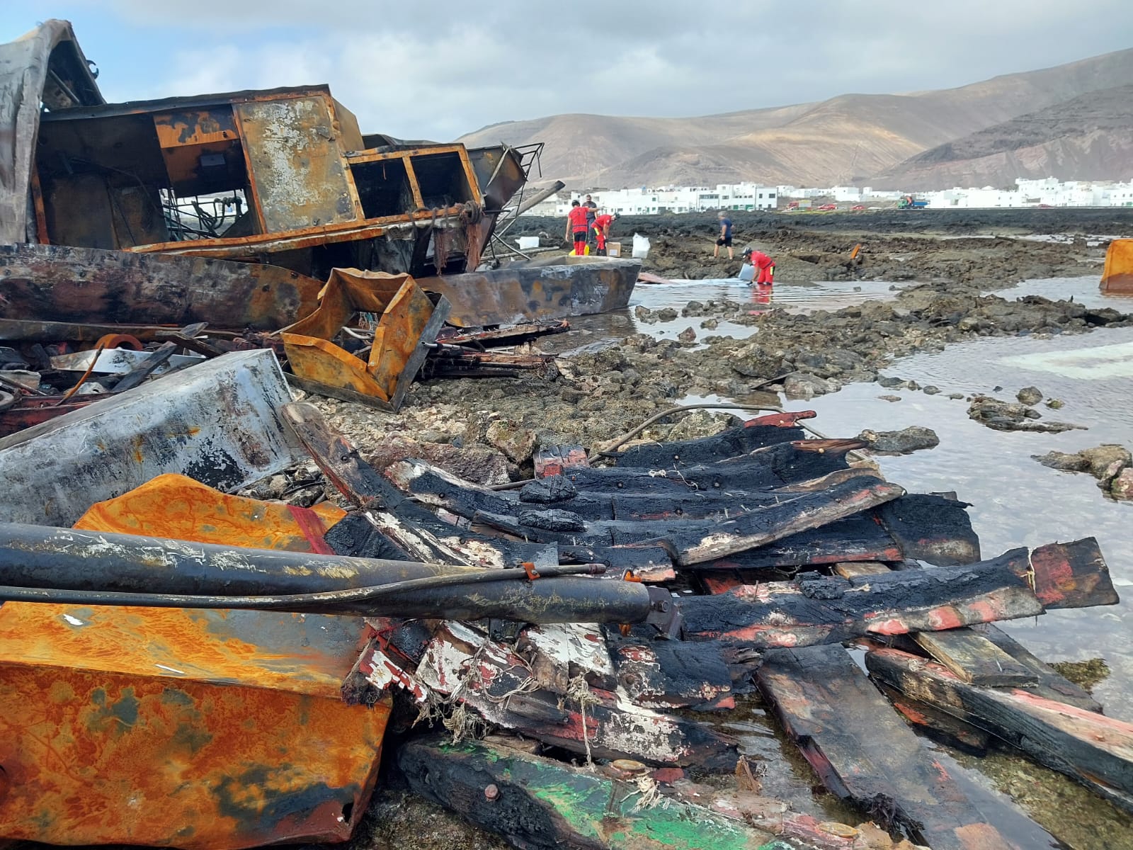 Imagen principal - Imágenes de los restos del pesquero encallado.