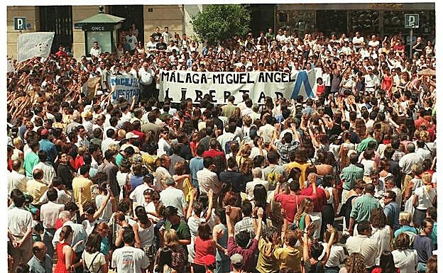 Imagen principal - Las autoridades muestran su rechazo al acto terrorista en la noche del sábado 12 de julio y los ciudadanos piden la libertad en la plaza de la Constitución, horas antes de cumplirse el plazo (arriba); altar a las puertas del Ayuntamiento (derecha); minutos de silencio en calle Larios la mañana del 14 de julio (izquierda)