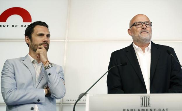 Lluis Corominas (d) y Roger Torrent, de Junts pel Sí, durante la rueda de prensa.