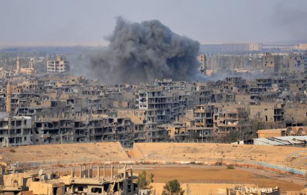 El humo de los combates, el pasado jueves, en la ciudad siria de Deir Ezzor. :: AFP