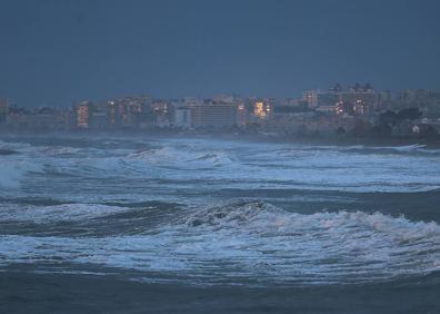 Imagen secundaria 1 - Operarios limpian el paseo marítimo de la capital. El fuerte oleaje llegó a una altura de hasta cuatro metros. Estado de la playa de Ferrara, en Torrox, tras el temporal. 
