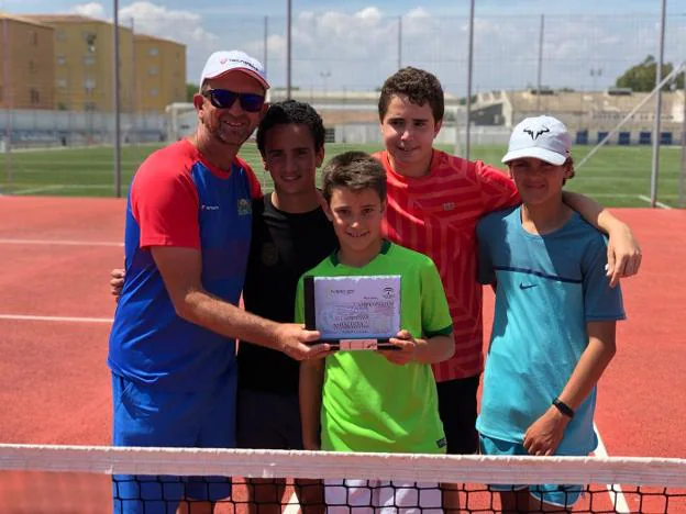 Los jóvenes tenistas del club malagueño posan con el trofeo junto a su capitán, José Roses. :: sur