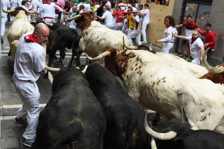 Se vivieron momentos de tensión en la curva de la Estafeta al quedar algún corredor atrapado entre la pared y los toros