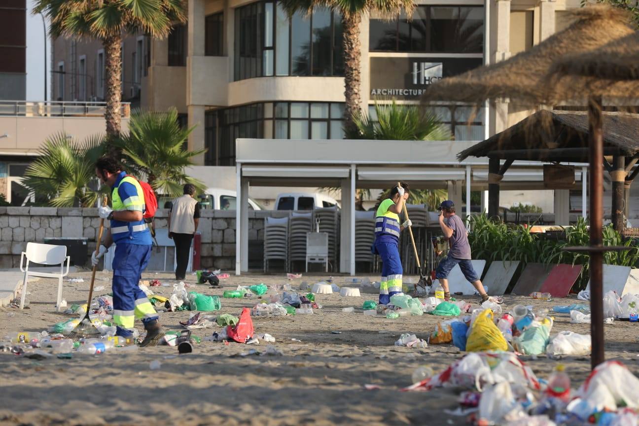 Operarios de Limasa se afanan en retirar los residuos de las miles de personas que cumplieron con la tradición del ritual de la noche de San Juan. En la imagen, residuos acumulados en la playa de la Malagueta.