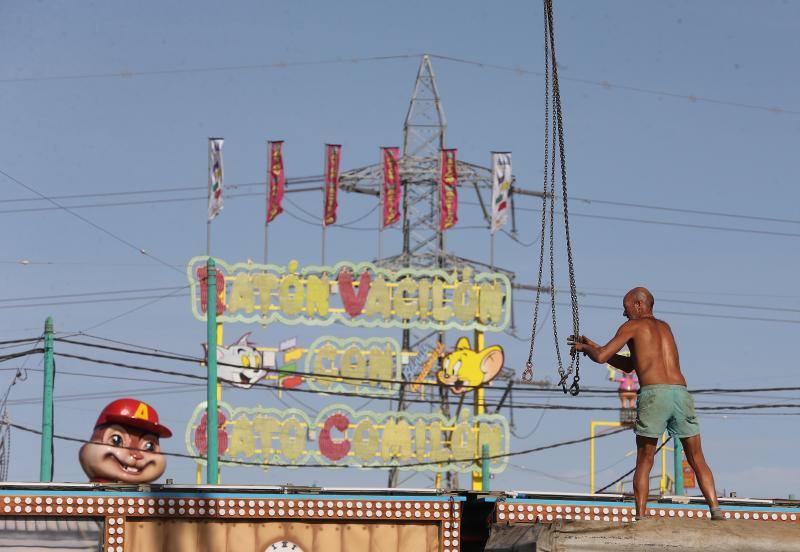 Feriantes, operarios municipales y de contratas y peñistas llevan semanas afanados en poner a punto todos los elementos que conforman esa ciudad efímera que es el Real de Cortijo de Torres.