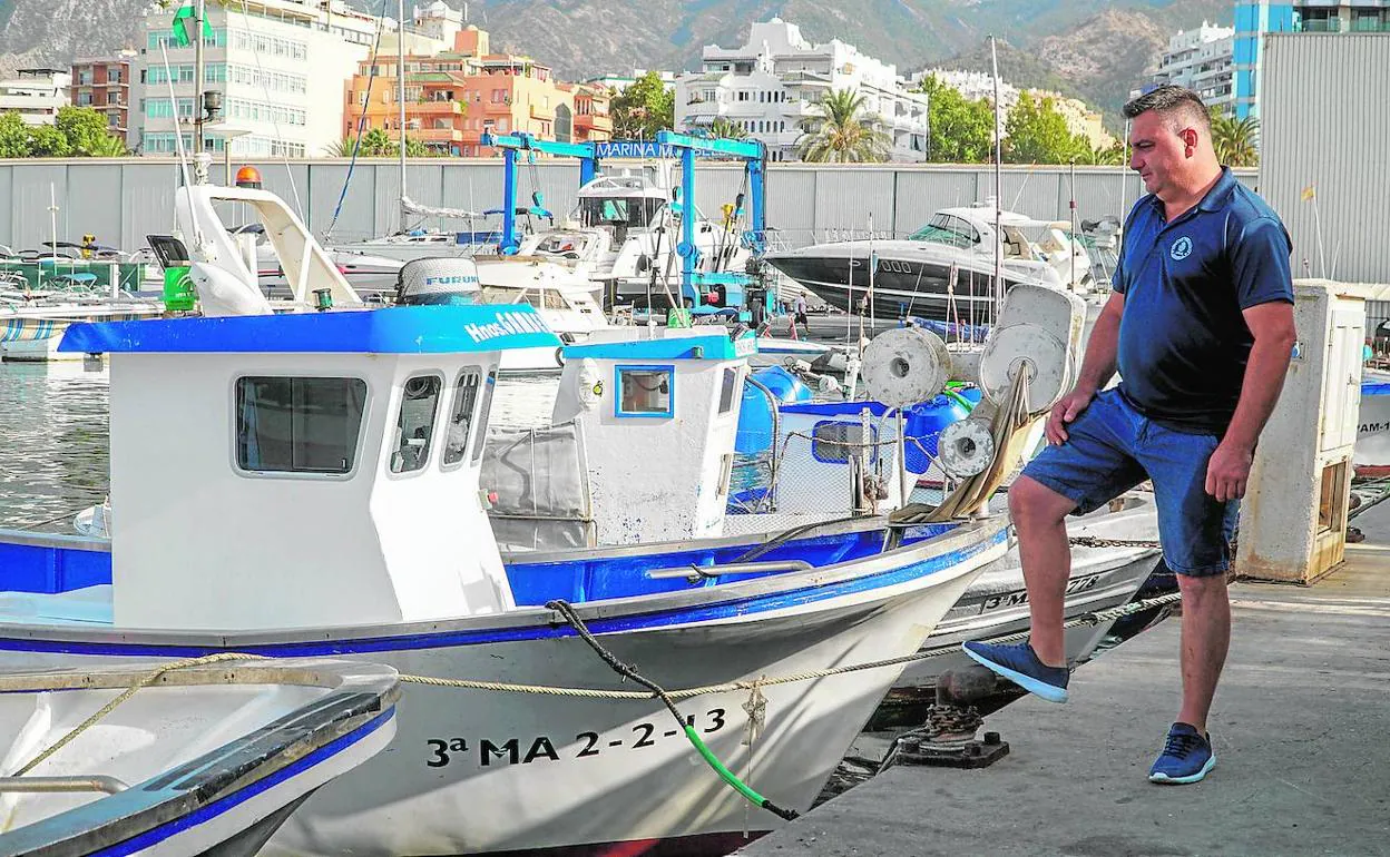 El patrón mayor de la Cofradía de Pescadores de Marbella, Manuel Haro, junto a los barcos anclados en el puerto.
