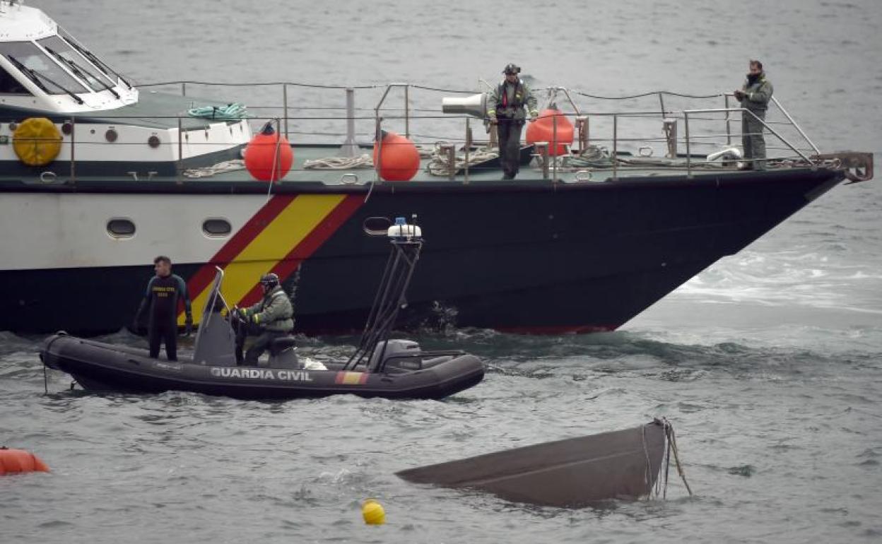 Efectivos de la Guardia Civil trabajan en reflotar el submarino. 