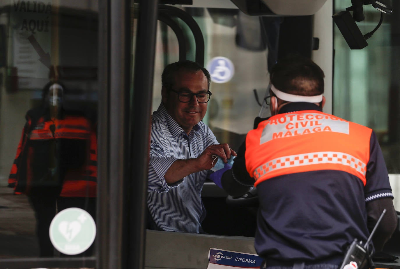 El estado de alarma deja estampas inéditas. Protección Civil comienza en Málaga el reparto de mascarillas a los trabajadores en los transportes públicos.