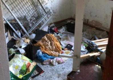 Imagen secundaria 1 - Arriba, destrozos en la terraza de la vivienda; abajo a la izquierda, restos de basura y ropa en el interior de Casa Elsa; y a la derecha, la puerta destrozada. 