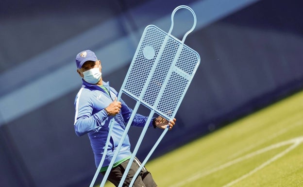 Pellicer, con mascarilla, porta una barrera de metal en un entrenamiento. 