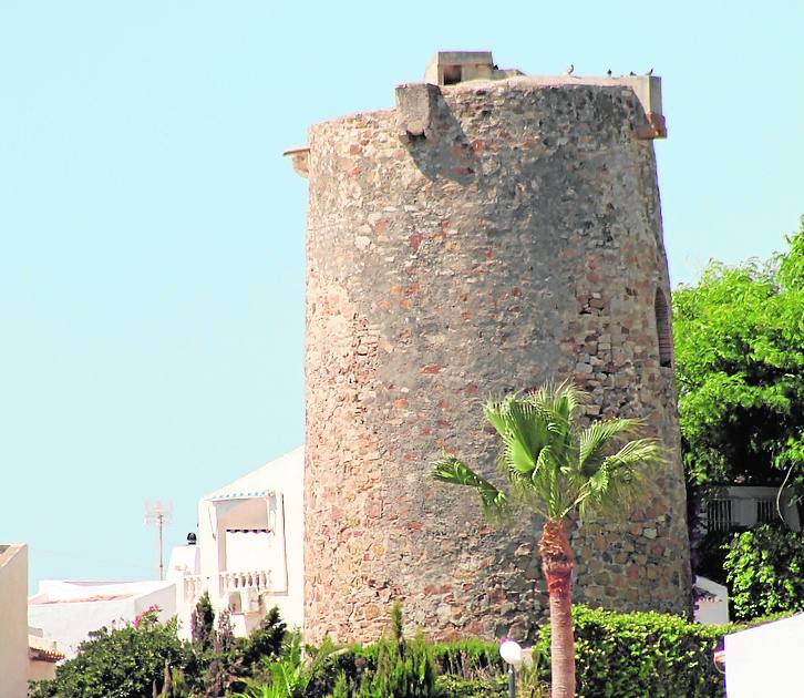 La torre de Arroyo Vaquero vigila el arenal desde una zona rocosa en la zona occidental de la cala 