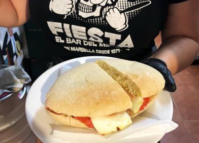 Imagen secundaria 1 - Arriba, Rubén, alma del Bar Fiesta del Mercado de Marbella, 28 años entre los favoritos de la gente local. Abajo: la especialidad de 'Fiesta, el bar del Mercao de Marbella' son los molletes, sobre todo el de carne mechada, de los que son fans famosos chefs. En la última foto, en el Mercado del Carmen, Encarnes de Cholo permite disfrutar de un chuletón recién cortado por el carnicero y hecho en brasas de encina 
