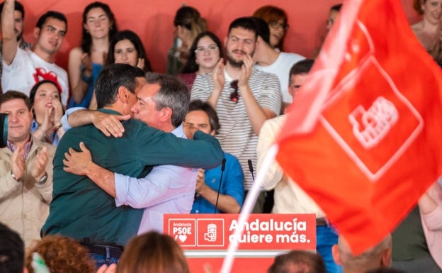 Juan Espadas abraza a Pedro Sánchez tras su intervención.