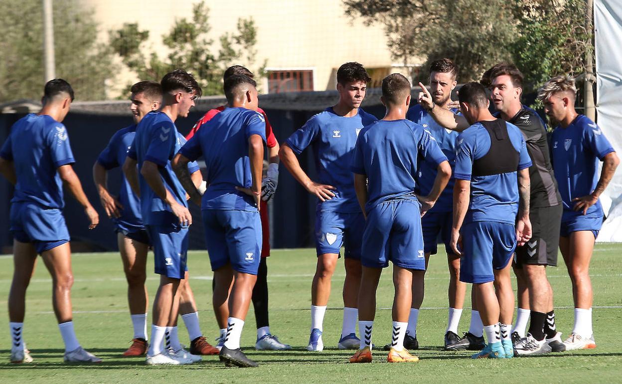 Jugadores del Málaga atienden a las indicaciones de Guede en el partido de entrenamiento de ayer.