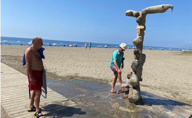 Imagen principal - Arriba, Fernando Delgado observa como se quita la arena Francisco Macías, en La Cala del Moral; abajo a la izquierda, vecinos de Algarrobo Costa, y a la derecha, los granadinos Ana María Tirado y Nicolás Peña, en el núcleo caleño. 