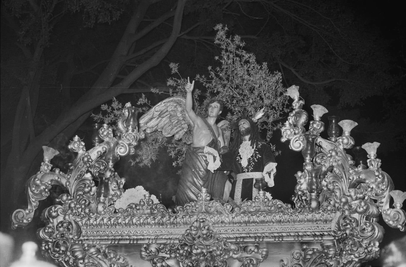 El grupo escultórico del Huerto en la noche del Domingo de Ramos de 1959. Esta hermandad cerraba por entonces la jornada inaugural de la Semana Santa. El día lo componían, además de la corporación de la iglesia de los Mártires, las cofradías de la Pollinica, Prendimiento y Cena. Ese año el cortejo lo presidió el jefe nacional del Sindicato del Olivo, Navarro y González de Canales.