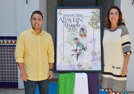 Francisco Burgos y Toñi Ledesma, junto al cartel de la Feria.