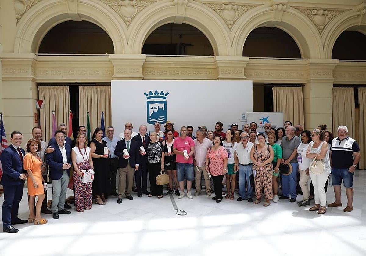 El alcalde, Francisco de la Torre, los representantes de CaixaBank, Maskom y Covap, junto con miembros de las asociaciones de reparto de alimentos de Málaga.