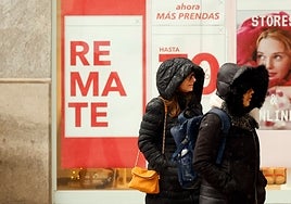 Dos mujeres se protegen del frío y la lluvia, ayer en el Centro de Málaga.
