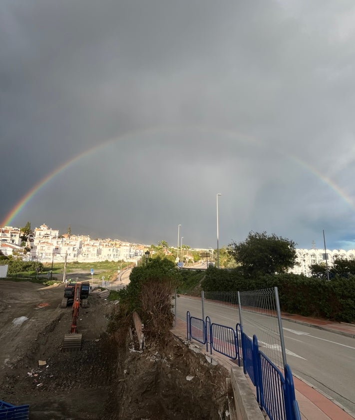 Imagen secundaria 2 - Arriba, La Navachica, el 'techo' de la Sierra Almijara, cubierta con un fino manto blanco, este martes; abajo a la izquierda, La Cadena, en la Sierra Almijara, también con nieve, y a la derecha, un espectacular arcoíris, este pasado lunes en Nerja.