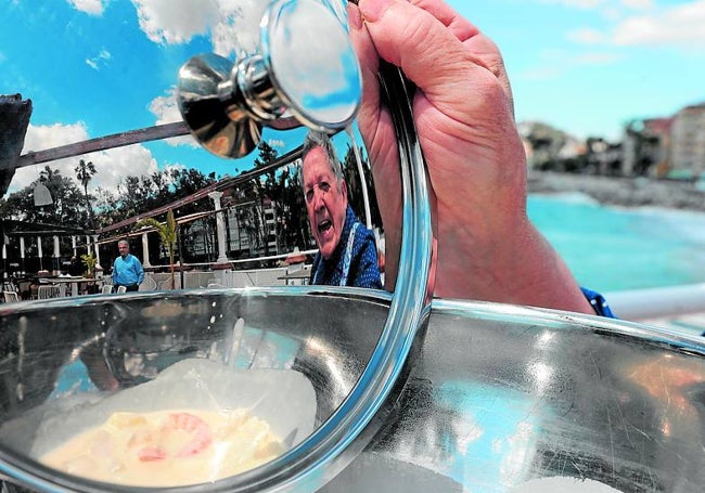 El veterano cocinero, reflejado en la tapa de una olla.