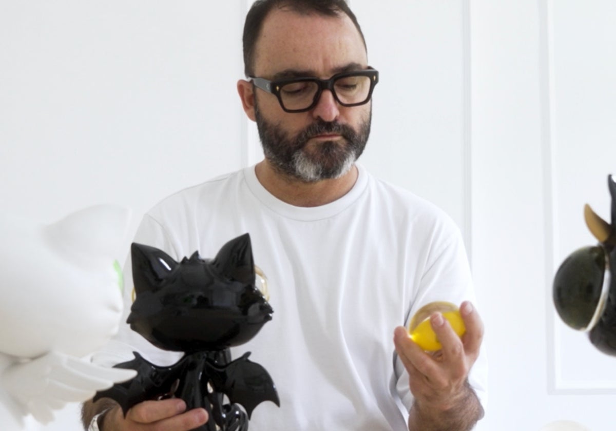 Javier Calleja observa uno de los ojos de cristal del la escultura del gato negro que se edita de forma individual.