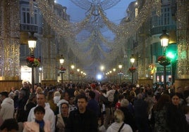 Miles de personas en la calle Larios esperan el espectáculo de luces.